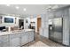 Kitchen with gray cabinets, stainless steel appliances, brick floors, and view to table at 307 Dogwood Dr, Mount Holly, NC 28120