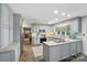 Kitchen with gray cabinets, an island, stainless steel appliances, and brick floor at 307 Dogwood Dr, Mount Holly, NC 28120