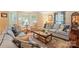 Cozy living room showcasing couches, chairs, rug, and multiple sources of natural light at 307 Dogwood Dr, Mount Holly, NC 28120