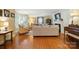 Bright living room featuring hardwood floors, a cozy seating area, and large windows at 307 Dogwood Dr, Mount Holly, NC 28120