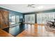 Spacious living room featuring hardwood floors, large windows with plantation shutters, and a rustic sliding barn door at 307 Dogwood Dr, Mount Holly, NC 28120
