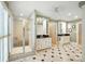 Large, well-lit bathroom featuring double vanities, large shower and decorative black and white tiled flooring at 307 Dogwood Dr, Mount Holly, NC 28120