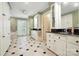 Bright bathroom with white cabinets, black granite countertops, tub, and decorative black and white tiled flooring at 307 Dogwood Dr, Mount Holly, NC 28120