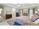 Spacious main bedroom featuring patterned wallpaper, hardwood furnishings, and a king size bed with a paisley comforter at 307 Dogwood Dr, Mount Holly, NC 28120