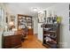 Inviting office space with a wooden desk, shelving and wood floors at 307 Dogwood Dr, Mount Holly, NC 28120