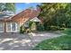 Brick home with well-manicured landscaping and a walkway leading to a private entrance at 307 Dogwood Dr, Mount Holly, NC 28120