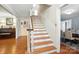 Elegant staircase with wood treads and white risers, seamlessly connecting the home's levels at 307 Dogwood Dr, Mount Holly, NC 28120