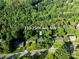 Aerial view of property showing the address among mature trees, a neighborhood, and a well-maintained landscape at 310 25Th Nw Ave, Hickory, NC 28601