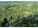 Overhead view of the property and surrounding neighborhood, showcasing its location and serene tree coverage at 310 25Th Nw Ave, Hickory, NC 28601