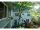 Backyard view with a small fenced yard, mature trees, an exterior staircase, and a blue back door at 310 25Th Nw Ave, Hickory, NC 28601
