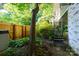Backyard with a wooden fence, lush greenery, and a set of stairs leading to the house at 310 25Th Nw Ave, Hickory, NC 28601