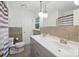 Bathroom with dual sinks, modern fixtures, neutral tile, and a bathtub with a shower at 310 25Th Nw Ave, Hickory, NC 28601