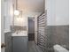 Bathroom with dual sinks, light-gray tile, and shower with a striped curtain at 310 25Th Nw Ave, Hickory, NC 28601