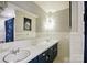 Bright white bathroom featuring dual sinks, large mirror, and tiled walls at 310 25Th Nw Ave, Hickory, NC 28601