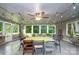 Sunroom dining area with ceiling fan, lots of windows and light, and string lights at 310 25Th Nw Ave, Hickory, NC 28601