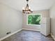 Dining room features a wood chandelier and window view of lush trees at 310 25Th Nw Ave, Hickory, NC 28601
