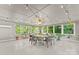 Bright dining room with many windows, a ceiling fan, and a table with seating for eight at 310 25Th Nw Ave, Hickory, NC 28601