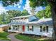 Charming two-story home with a welcoming front porch, painted brick, a red door, and beautifully landscaped yard at 310 25Th Nw Ave, Hickory, NC 28601