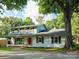 Charming two-story home featuring classic brickwork, a red front door, and inviting curb appeal at 310 25Th Nw Ave, Hickory, NC 28601