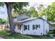 Charming white brick home with black shutters, lush lawn, and mature trees providing shade at 310 25Th Nw Ave, Hickory, NC 28601