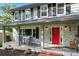 Charming home with a covered front porch and a vibrant red front door at 310 25Th Nw Ave, Hickory, NC 28601