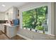 Kitchen counter and window overlooking backyard with large tree and other greenery at 310 25Th Nw Ave, Hickory, NC 28601