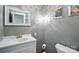 Powder room with decorative mirror, modern light fixture, toilet, and sink at 310 25Th Nw Ave, Hickory, NC 28601