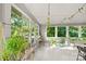 Bright sun room with plant decor, large windows and natural light with white wood floors at 310 25Th Nw Ave, Hickory, NC 28601