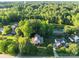 Aerial view of a home nestled among lush trees and overlooking a serene pond at 322 Oakview Dr, Salisbury, NC 28146