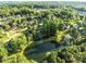 Aerial view of a neighborhood featuring mature trees, ponds, and tree-lined streets at 322 Oakview Dr, Salisbury, NC 28146