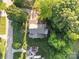 Aerial view of a home with manicured lawns, mature trees, a pond and a long driveway at 322 Oakview Dr, Salisbury, NC 28146