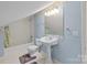 Bathroom with blue walls, pedestal sink, and shower-tub combination at 322 Oakview Dr, Salisbury, NC 28146