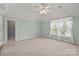 Spacious bedroom features light green walls, carpet, ceiling fan and natural light at 322 Oakview Dr, Salisbury, NC 28146