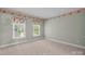Bedroom featuring neutral walls, carpet, and a pair of windows at 322 Oakview Dr, Salisbury, NC 28146