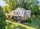 Beautiful two-story home with a brick exterior, lovely landscaping, and a view of the nearby lake at 322 Oakview Dr, Salisbury, NC 28146