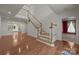 Bright foyer featuring hardwood floors, a staircase, and an open view to other living spaces at 322 Oakview Dr, Salisbury, NC 28146