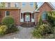 Elegant front entrance with a brick facade, white columns, and a neatly landscaped walkway at 322 Oakview Dr, Salisbury, NC 28146