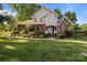 Charming two-story home with beautiful landscaping, manicured lawn, brick facade, and bright white trim at 322 Oakview Dr, Salisbury, NC 28146