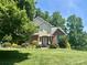 Charming two-story home with landscaped yard and brick accents, surrounded by mature trees at 322 Oakview Dr, Salisbury, NC 28146