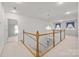 Upstairs hallway featuring carpet, wood railing, and decorative chandelier at 322 Oakview Dr, Salisbury, NC 28146