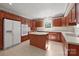 Traditional kitchen with wood cabinetry, modern appliances, central island, and neutral countertops for ample workspace at 322 Oakview Dr, Salisbury, NC 28146