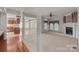 Open-concept living room features hardwood floors, carpet, fireplace, and access to kitchen and outdoor areas at 322 Oakview Dr, Salisbury, NC 28146