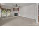 Bright living room with large windows, fireplace, neutral carpet, and access to outdoor space provides ample natural light at 322 Oakview Dr, Salisbury, NC 28146