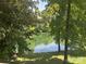 Beautiful pond with trees and light reflecting on the water at 322 Oakview Dr, Salisbury, NC 28146