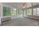 Bright sunroom with multiple windows and carpet at 322 Oakview Dr, Salisbury, NC 28146