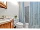 Cozy bathroom features a toilet, shower and single vanity with light blue shower curtain at 3311 Camden Rd, Marshville, NC 28103