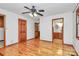 Primary bedroom featuring hardwood floors, a ceiling fan, and ensuite bathroom access at 3311 Camden Rd, Marshville, NC 28103