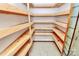 Walk-in pantry features wood shelving for optimal storage and organization at 3311 Camden Rd, Marshville, NC 28103