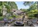 Backyard fire pit surrounded by Adirondack chairs and a beautiful outdoor space at 3717 Bounty Ct, Matthews, NC 28104