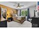 Bedroom featuring a rustic wood wall with a decorative deer mount, a window, and closet at 3717 Bounty Ct, Matthews, NC 28104